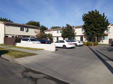 A white car is parked in front of a house.