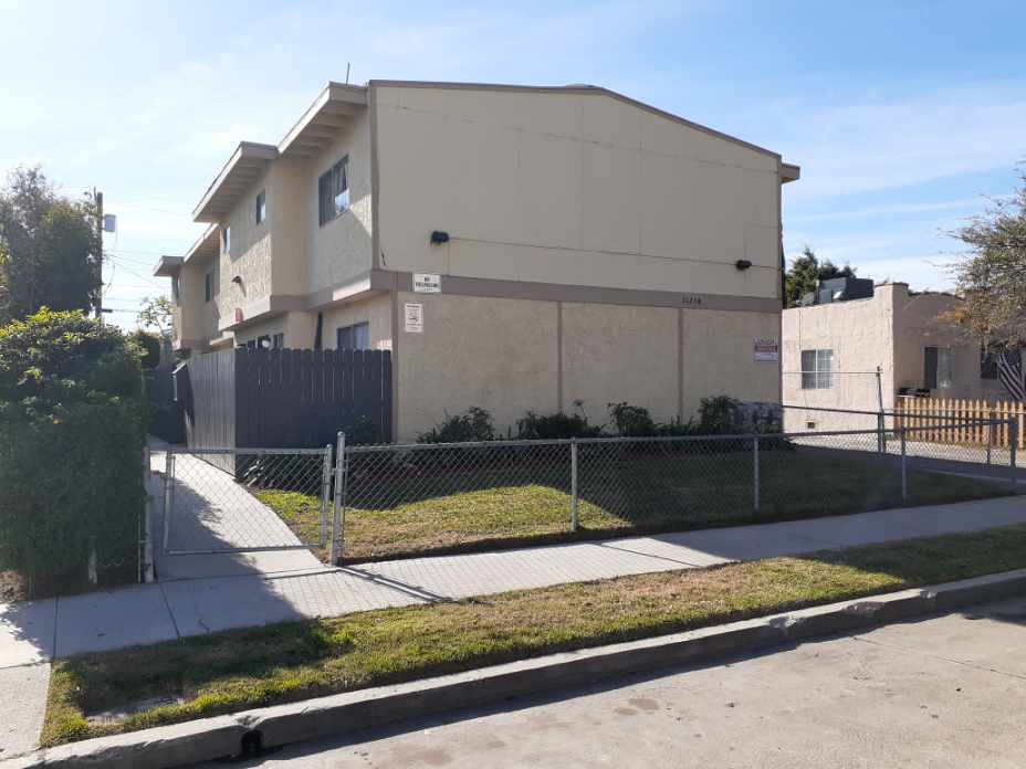 A building with a fence in front of it.