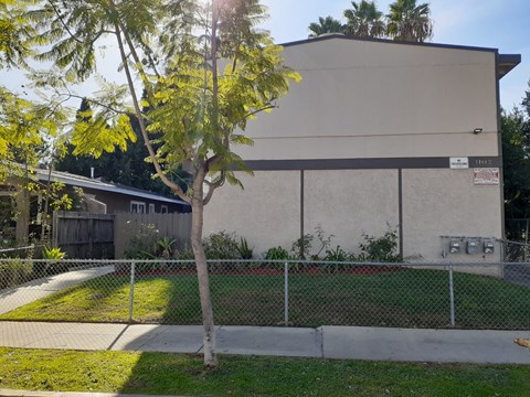 A building with a tree in front of it.