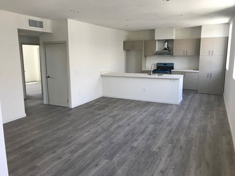 A room with a white counter and a stove top oven.