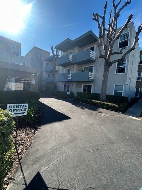 A sunny day at the rental office in front of apartment buildings.