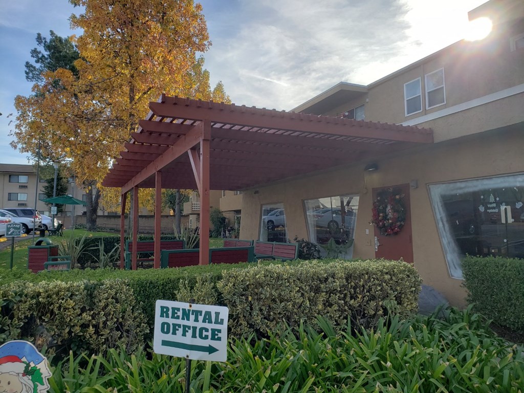 a rent office sign in front of a building