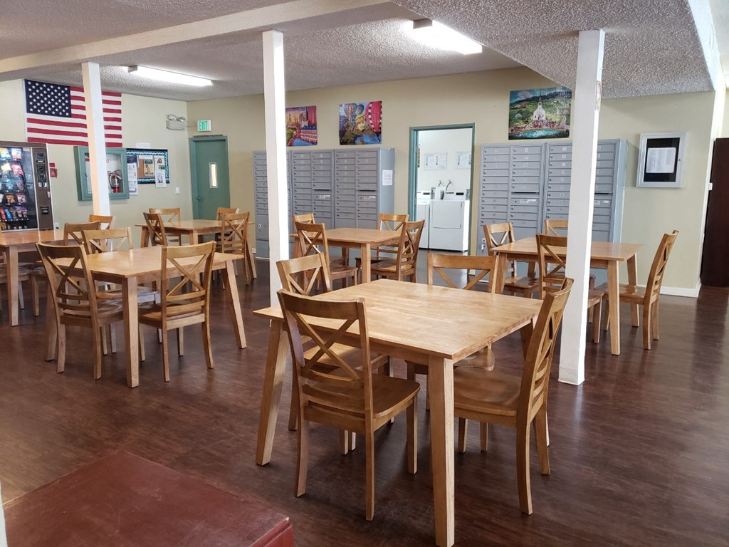 a large dining room with wooden tables and chairs