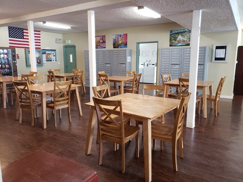 a large dining room with wooden tables and chairs