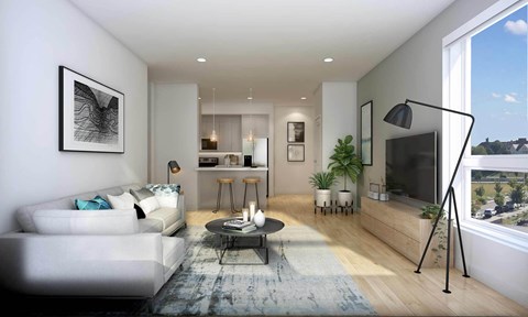 A modern living room with a white sofa, a coffee table, and a large window.