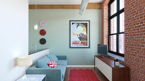 A living room with a grey couch and a red carpet.