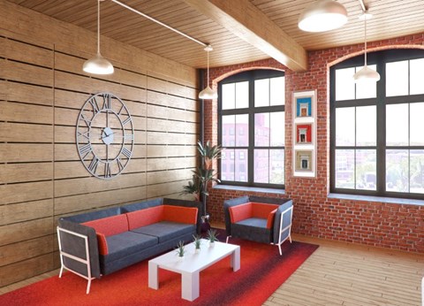 A living room with a couch, chair, and a clock on the wall.