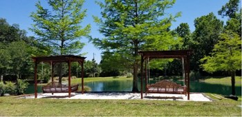 2 Pergola swing beds located on top of sand box located near the pond. - Photo Gallery 14