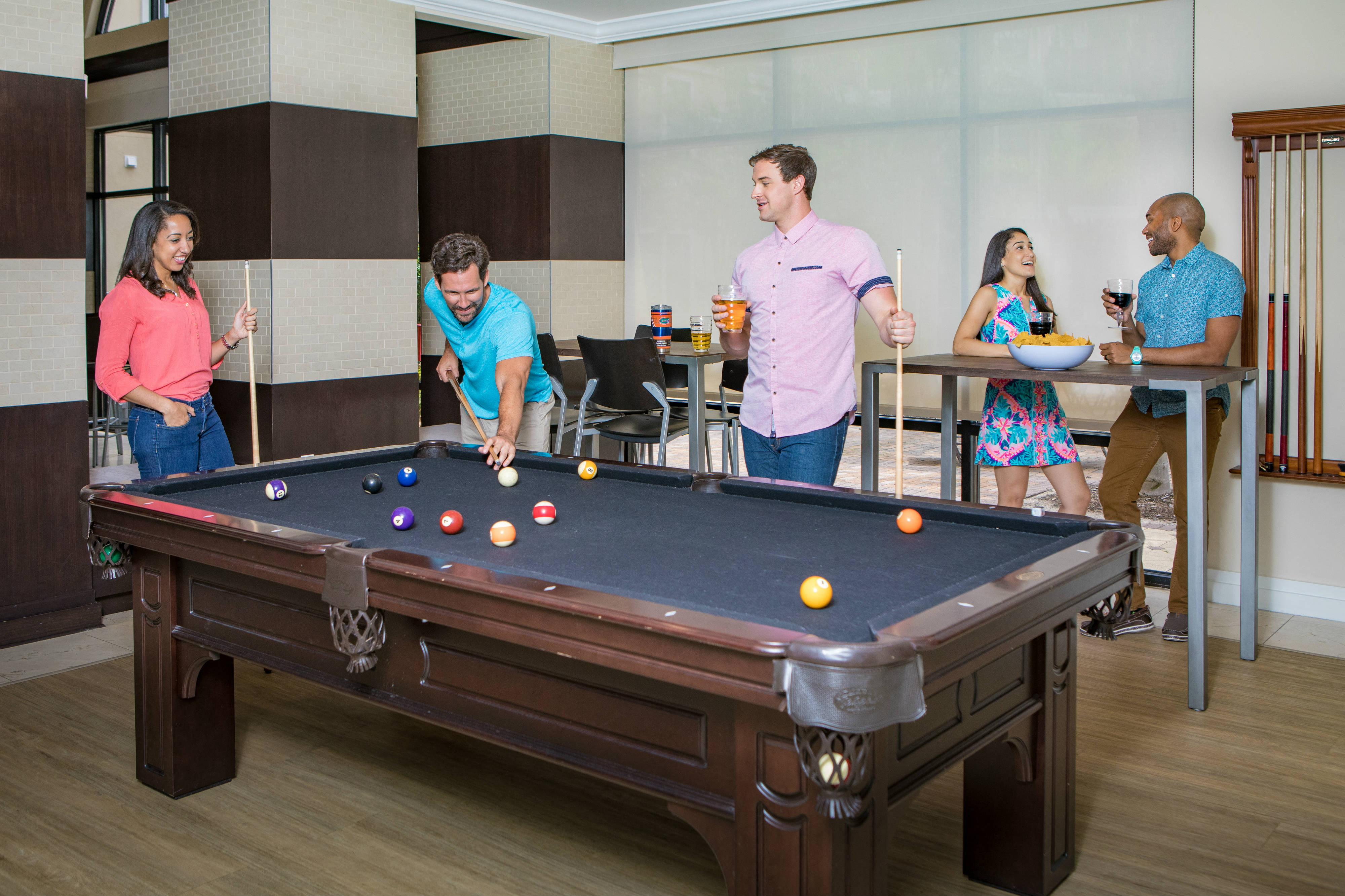 People playing billiards at The Bartram Apartments in Gainesville, FL 32608