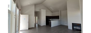 an empty room with white walls and a fireplace