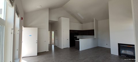 an empty room with white walls and a fireplace