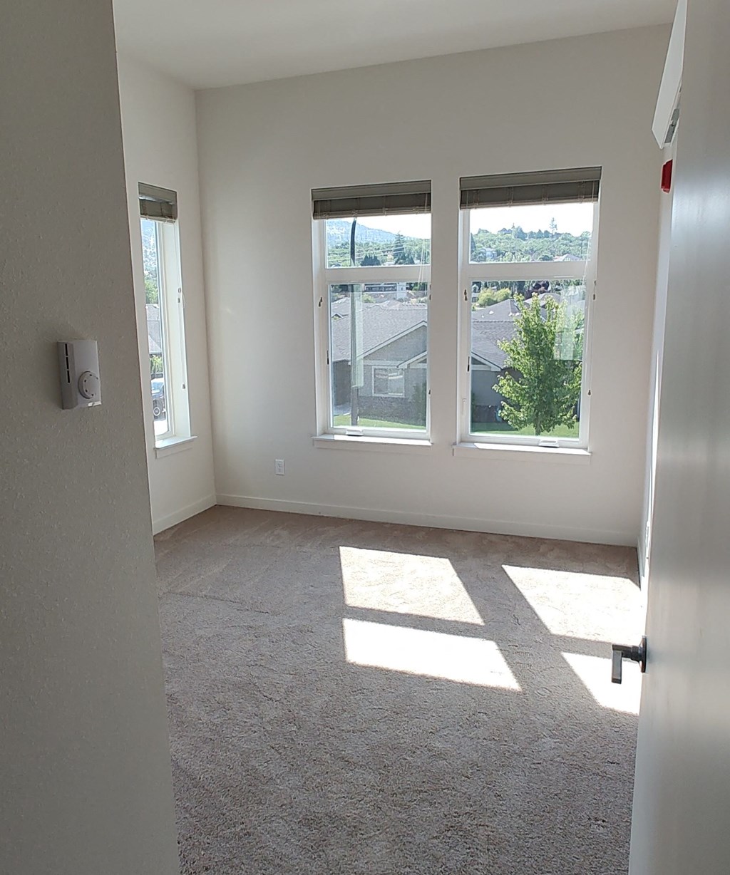 an empty room with three windows