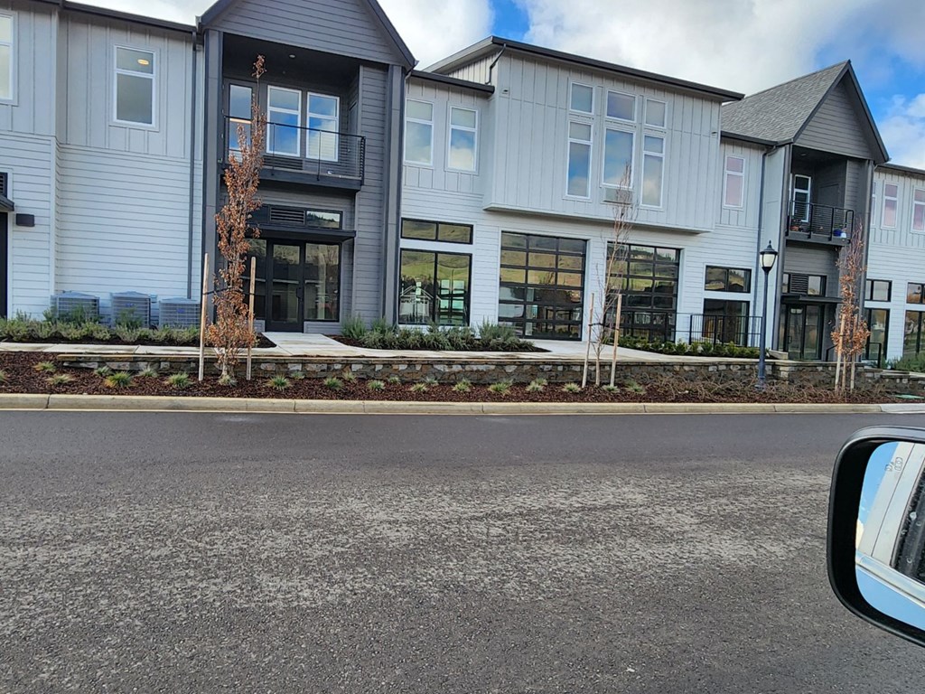 a view of a building from the side of a street