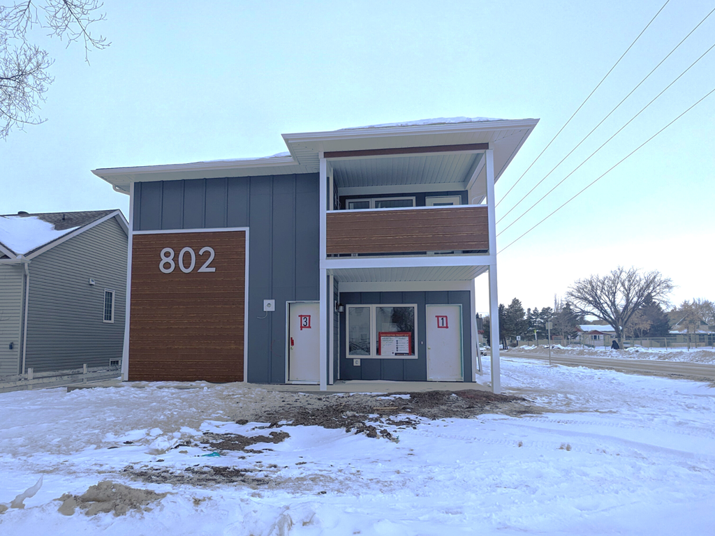the front of a building with snow on the ground