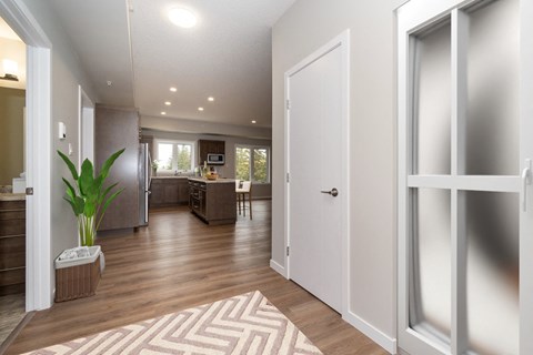 a view of a living room and kitchen from a door
