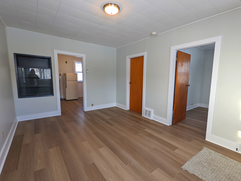 a living room with wood flooring and a fireplace