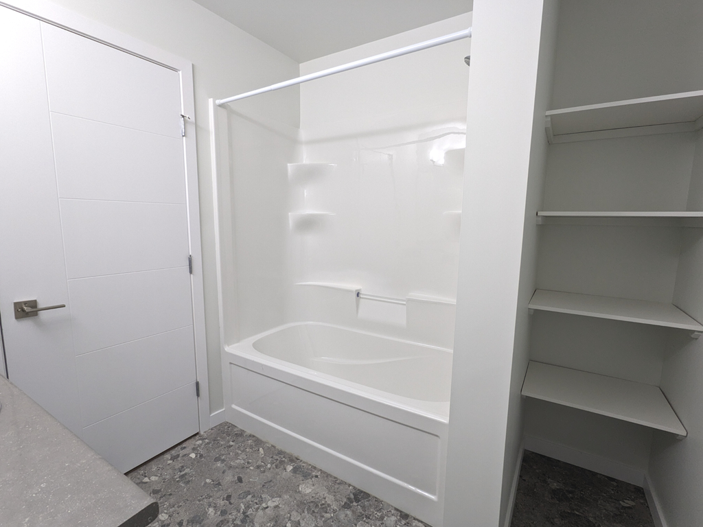 a small bathroom with a shower and a closet