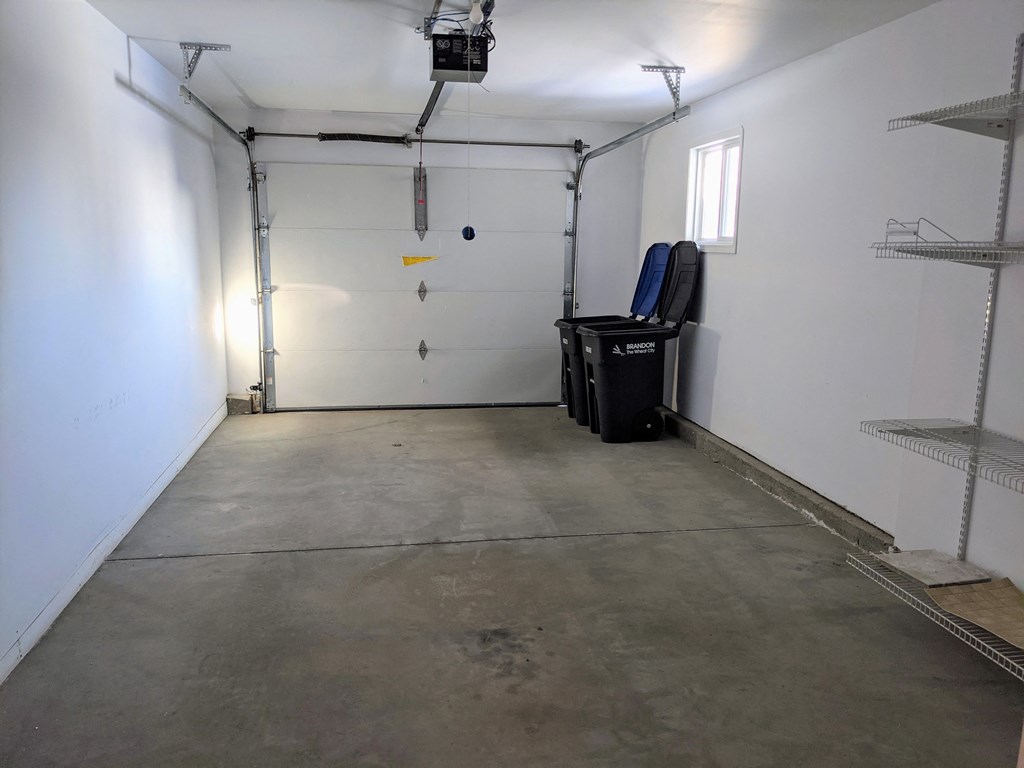 a clean garage with white walls and a white door