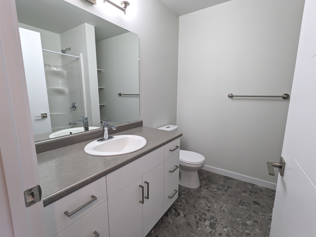 an empty bathroom with a sink and a toilet
