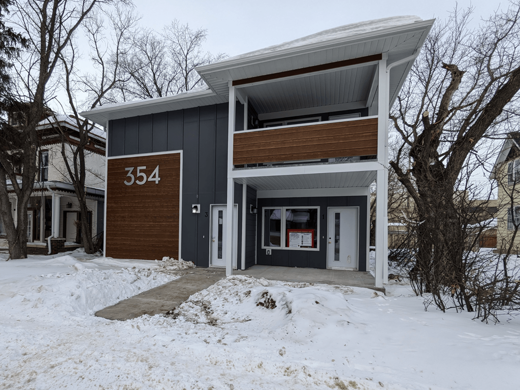 the front of a house with snow on the ground