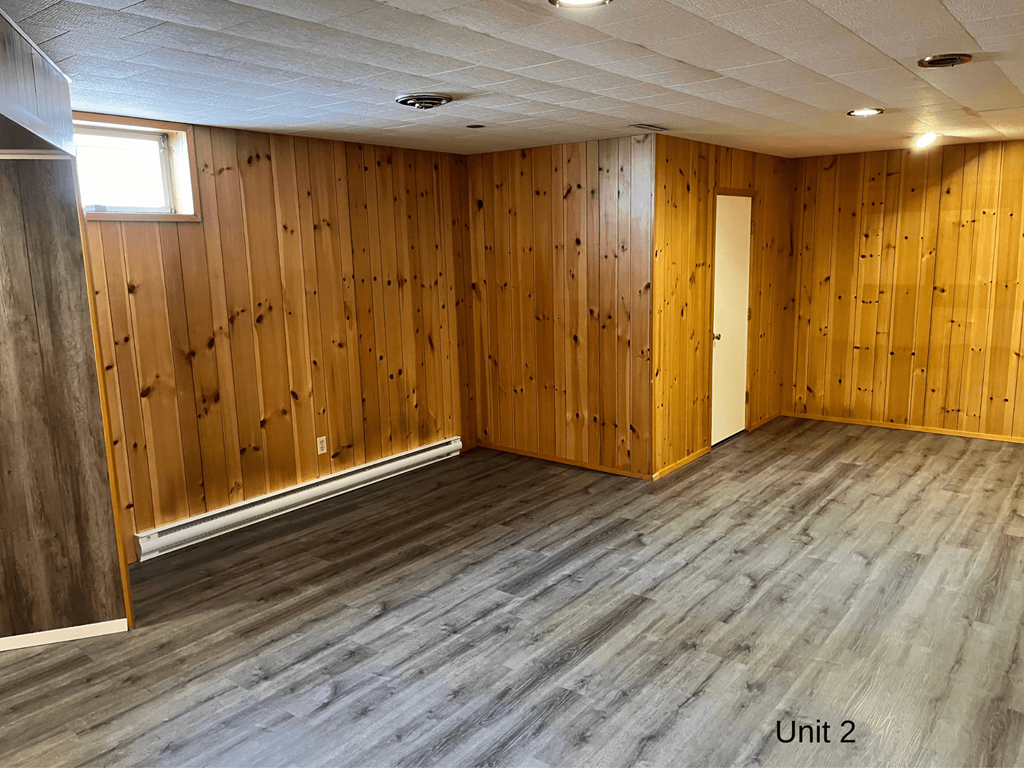 an empty room with wooden walls and wooden floors