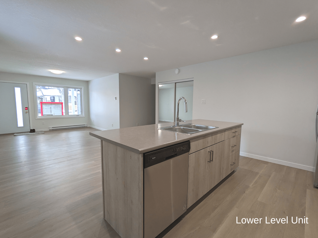 an empty kitchen with a large island in the middle of it
