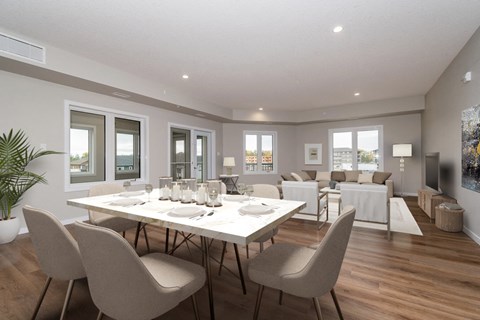 a living room with a dining room table and chairs