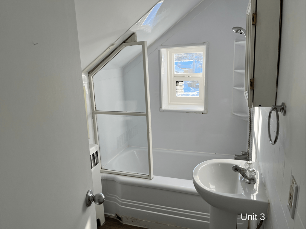 a small bathroom with a sink and a window