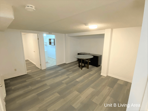 a living room with a hard wood floor and a table