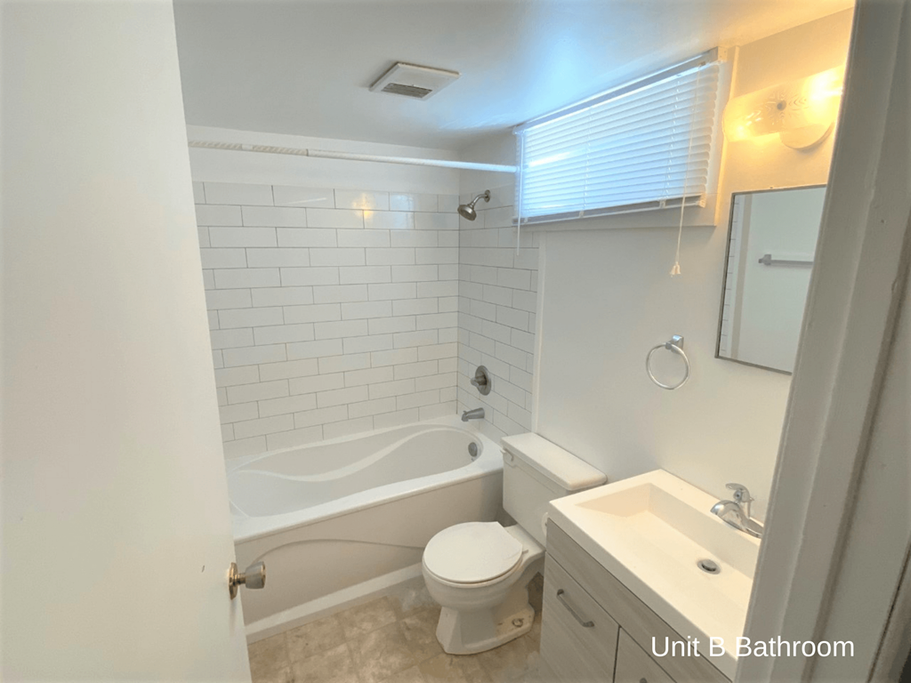 a small bathroom with a tub and a toilet and a sink