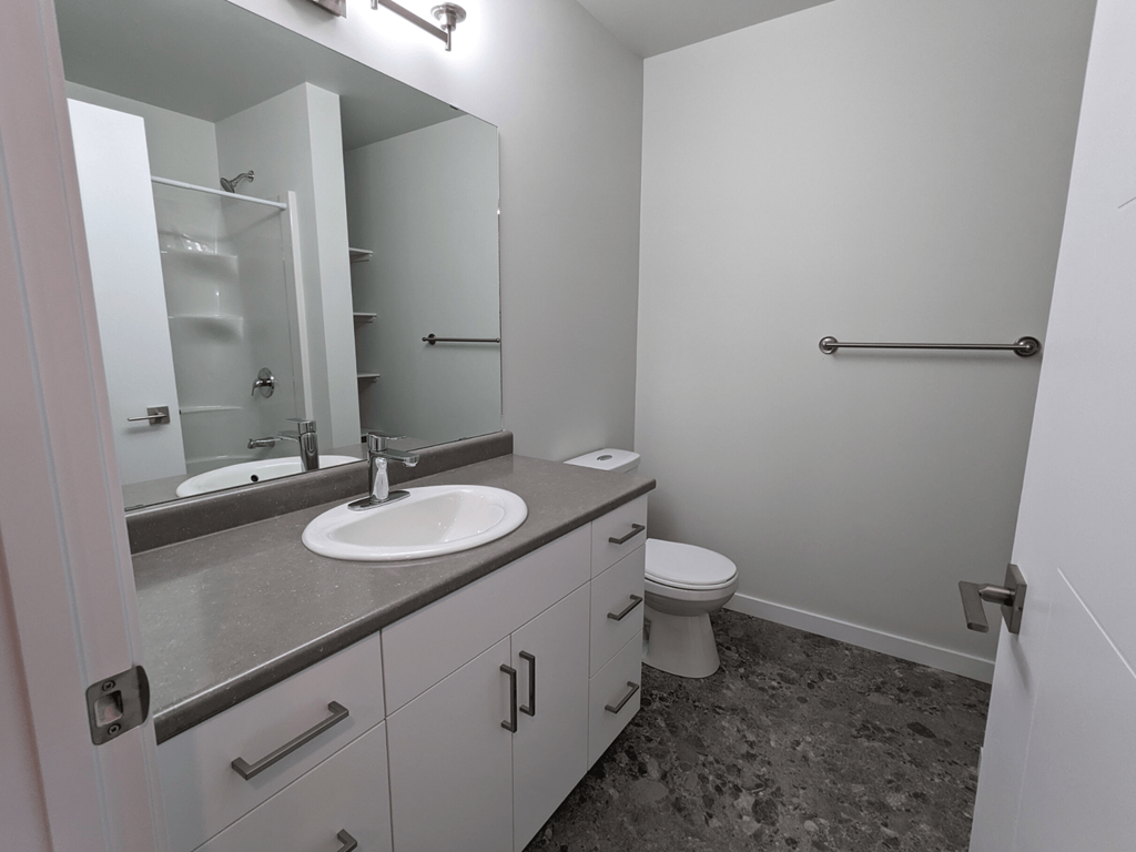 an empty bathroom with a sink and a toilet