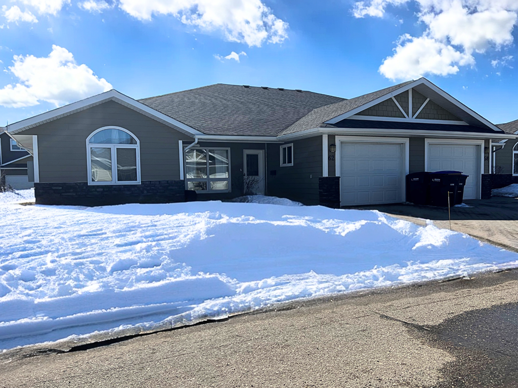 a snow covered yard in front of a house