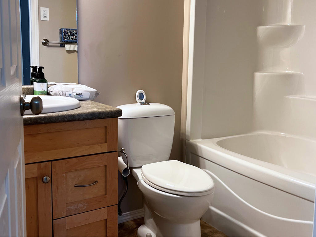 a bathroom with a toilet and a sink and a bath tub