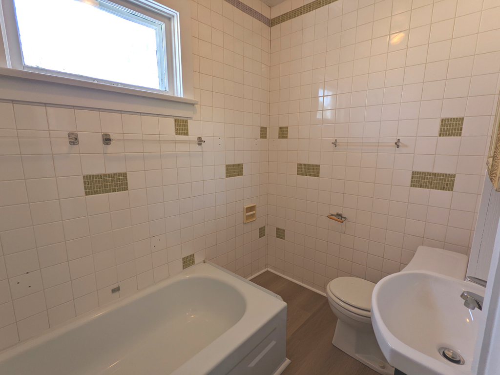 a bathroom with a sink toilet and a bath tub