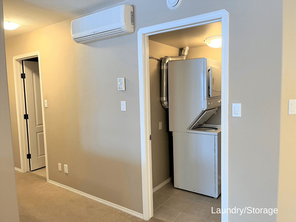 a hallway with a refrigerator and an open door to a kitchen