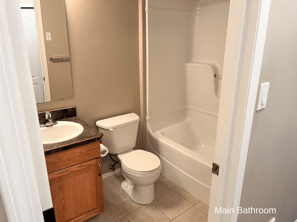 a bathroom with a toilet and a sink and a bath tub