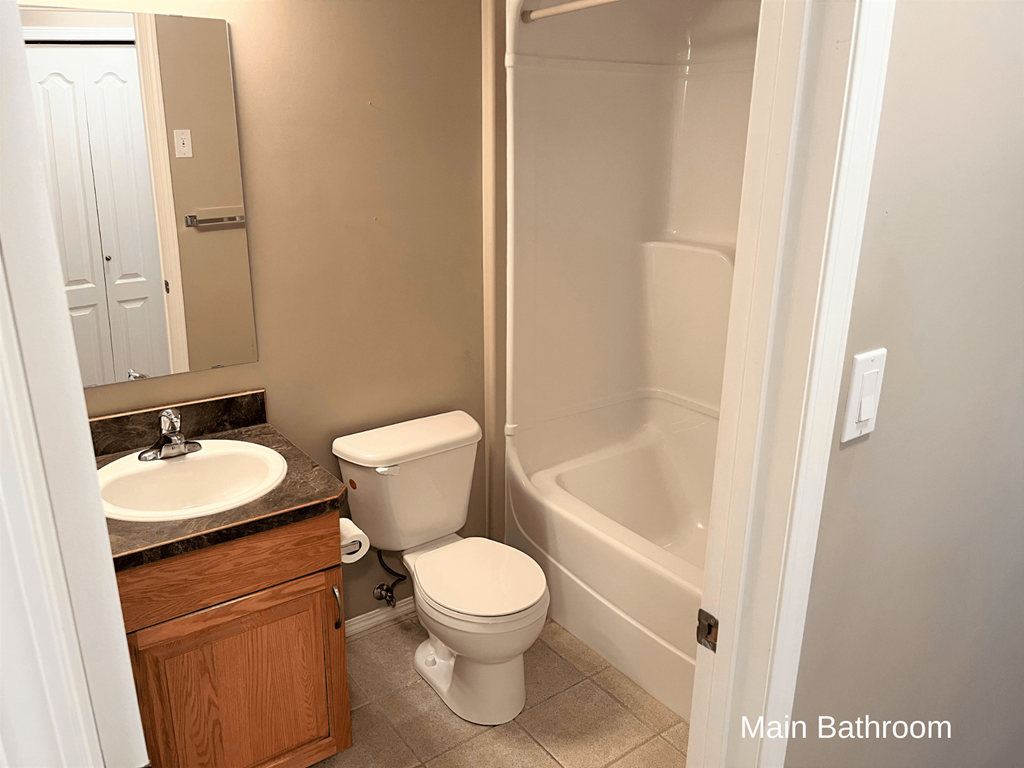 a bathroom with a toilet and a sink and a bath tub