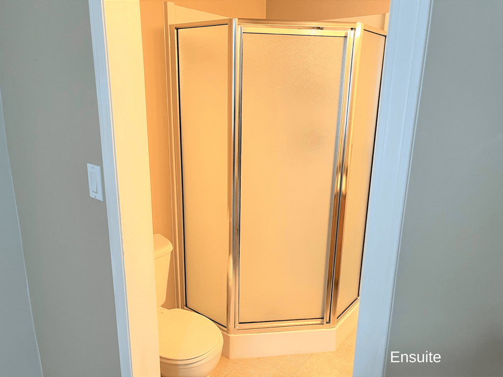 a small bathroom with a shower and a toilet