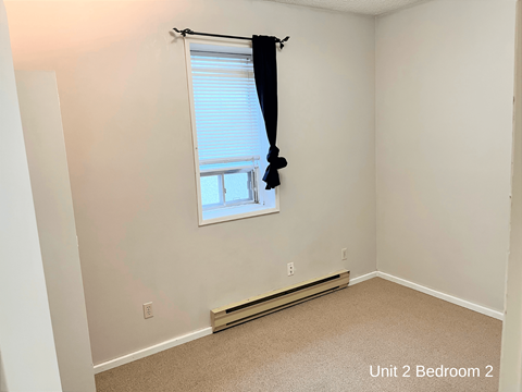 a small bedroom with a window and a window sill