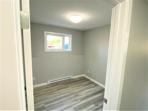 a room with a hard wood floor and a window