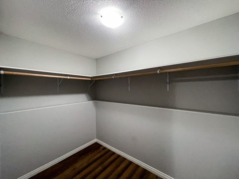 the living room of an empty house and wood floors