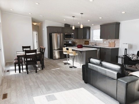A modern kitchen with a dining table and a couch.