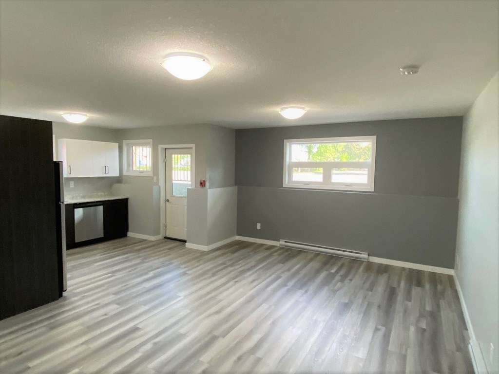 an empty living room and kitchen in a new home