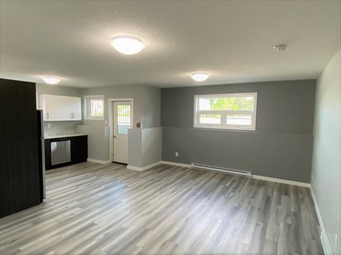 an empty living room and kitchen in a new home