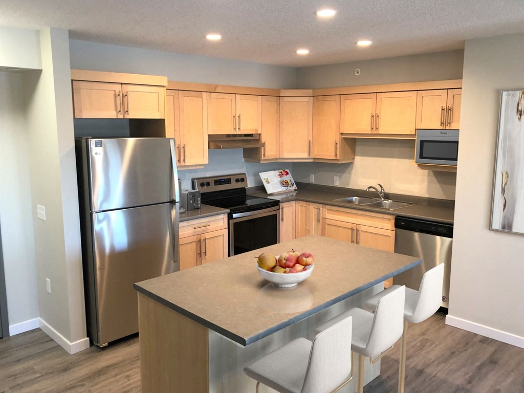 a kitchen with stainless steel appliances and wooden cabinets