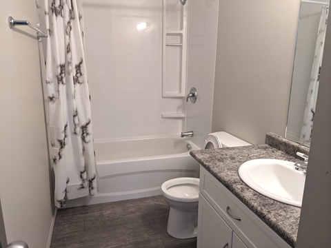 a small bathroom with a shower toilet and sink