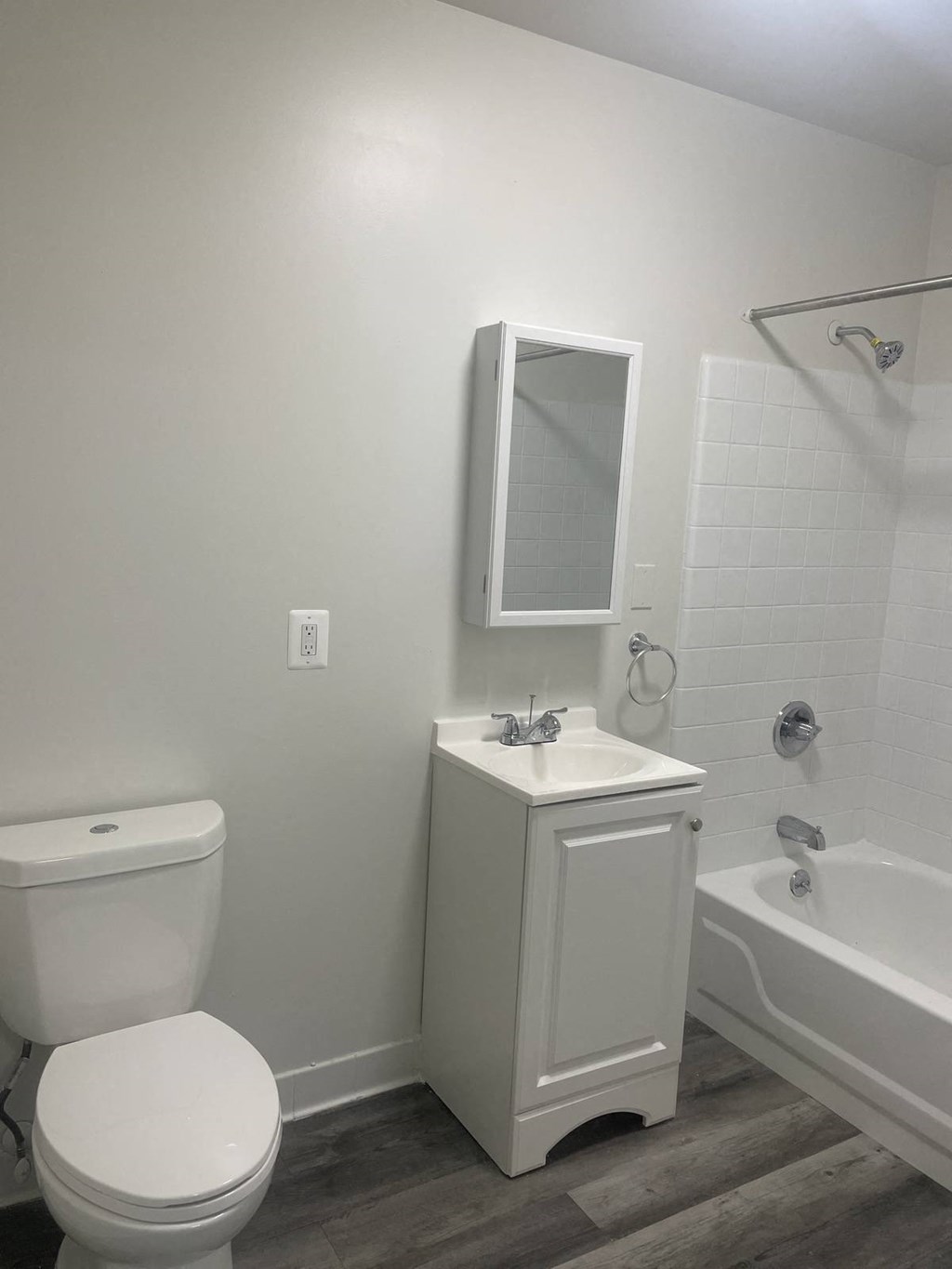 a bathroom with a toilet and a sink and a tub