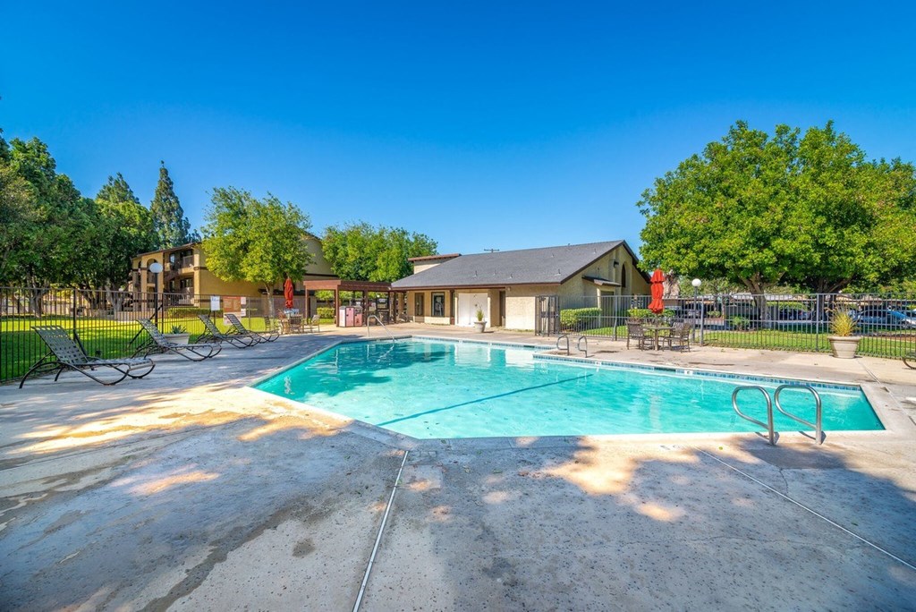 A large outdoor swimming pool with a building in the background.