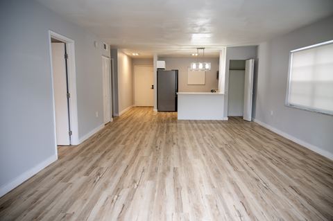 an empty living room and kitchen in a new home