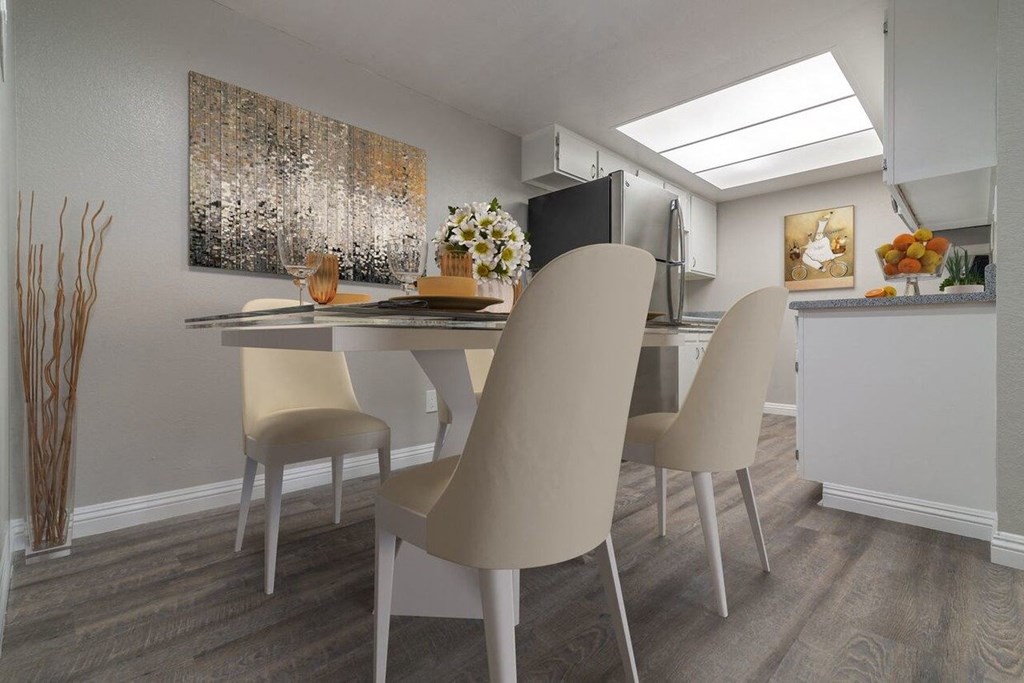 A dining room with a table and chairs.